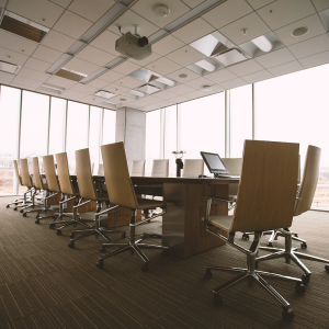 An image showing office desks in a meeting room.