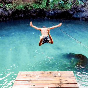 A man jumping into a lake
